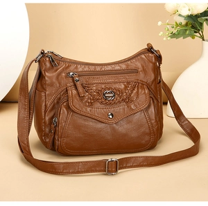 Brown faux leather crossbody bag with woven flap detail and multiple zipper compartments