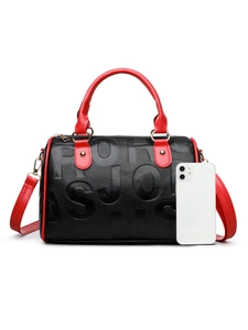Detail of Boston bag showing large embossed letters and black lychee leather texture