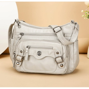 Close-up of the light gray PU leather crossbody bag featuring multiple zipper pockets