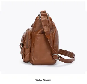 Side view showing multi-layer zipper pockets of the brown PU leather shoulder bag