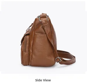 Side view of brown soft leather crossbody bag showing multi-pockets and adjustable strap