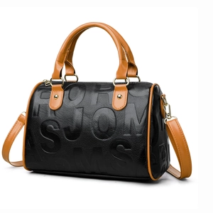 Detail of Boston bag showing textured leather, fashion embossing and protective bottom studs