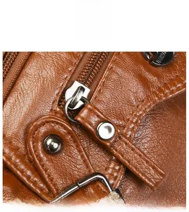 Close-up of smooth metal zipper and durable hardware on brown leather shoulder bag