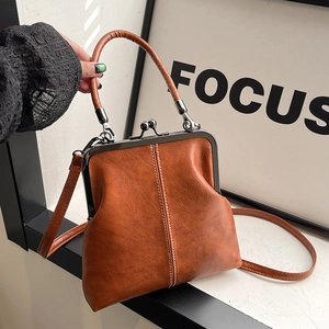 Vintage caramel brown shell bag with metal clasp and structured top handle for women