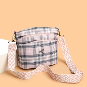 Pink and grey plaid crossbody bag with wide shoulder strap and kangaroo metal logo