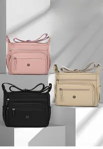 Close-up of nylon crossbody bag with multiple zipper pockets and water-resistant fabric