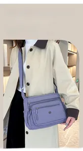 Waterproof purple nylon crossbody bag with multi-layer zippers and adjustable strap