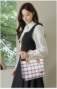 Detail of pink plaid canvas tote bag with leather handles and Jinpin logo patch