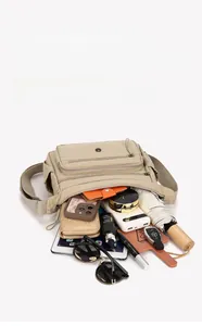 Detailed view showing large capacity of the khaki nylon messenger bag with multiple pockets