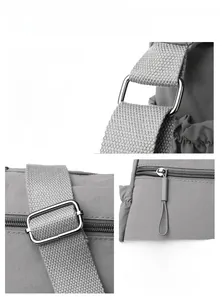 Detail of grey nylon shoulder bag with silver hardware buckles and woven straps