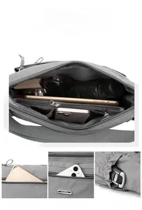 Detail of grey nylon crossbody bag showing spacious main compartment and zip pockets