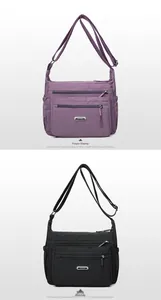 Detail view of purple and black nylon crossbody bags with multi-layer zipper pockets