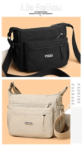 Detail of multi-pocket nylon crossbody bag with metal logo and adjustable wide strap