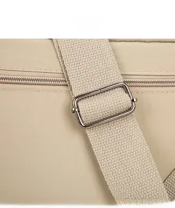 Detail of nylon shoulder bag showing silver metal buckle and sturdy woven strap quality