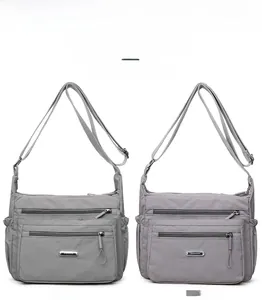 Detail view of large capacity nylon crossbody bags with multiple zipper compartments