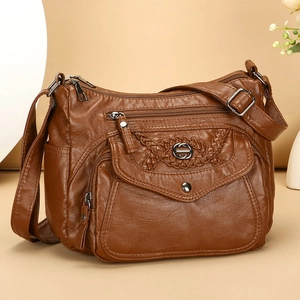 Deep brown soft faux leather crossbody bag with multi-pocket design and woven details