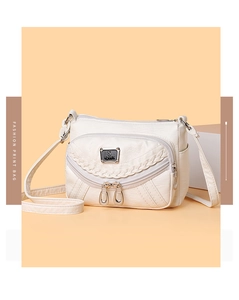 Detail view of white soft PU leather crossbody bag featuring multiple zippers and S sport logo