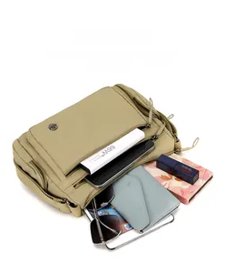 Top view of khaki oxford bag showing spacious interior with multiple zipper pockets