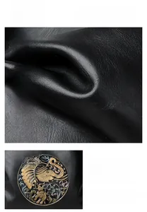 Close-up of vintage elephant relief badge on black lychee grain leather tote bag