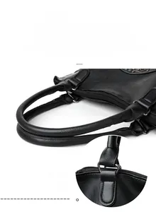 Detail of reinforced round top handles and durable stitching on black tote bag