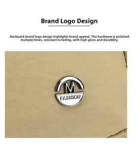 Macro shot of polished silver metal logo on khaki oxford fabric with durable texture