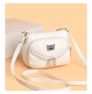Detail of white multi-pocket faux leather crossbody bag with S-sport logo and woven trim