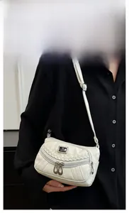 Detailed view of white faux leather crossbody bag with multi-zipper pockets and sport logo