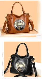 Detail of vintage tote bags with ethnic elephant embossed patterns in brown and black