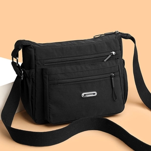 Black lightweight nylon crossbody bag with multi-zipper pockets and adjustable wide strap