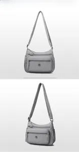 Vue détaillée du sac bandoulière en nylon gris avec plusieurs poches zippées et sangle