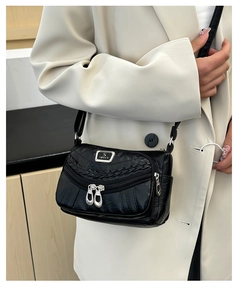 Detail of black faux leather crossbody bag with dual zipper pockets and S-sport logo