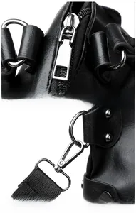 Macro view of polished silver metal zipper and durable strap hook on black tote bag