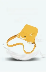 Macro shot of lightweight yellow nylon crossbody bag with feathers showing airy portability