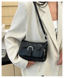Detailed view of black wrinkled PU leather shoulder bag with silver ring hardware