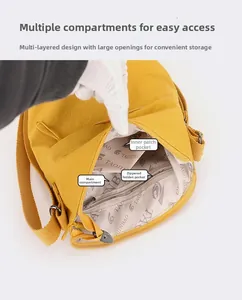Detail view of yellow nylon crossbody bucket bag showing multi-pocket interior layout