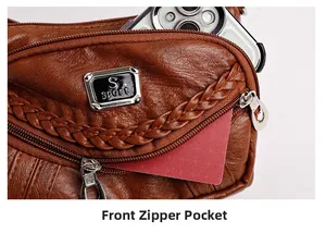 Detail view of the brown leather bag front zipper pocket with S sport metal emblem