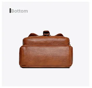 Detailed bottom view of large capacity brown leather shoulder bag showing quality stitching