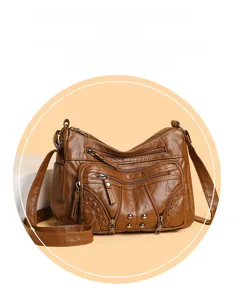 Close-up of brown vintage crossbody bag featuring multi-layer zippers and woven details