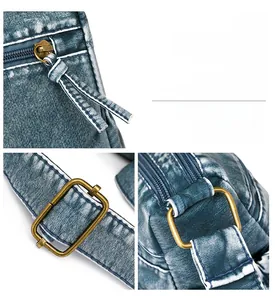 Detailed view of vintage washed blue bag hardware featuring bronze zippers and metal buckles