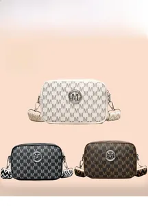 Détail de sacs bandoulière en cuir avec imprimé monogramme et large sangle à motifs