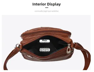 Internal view of brown faux leather crossbody bag showing main pockets and compartments