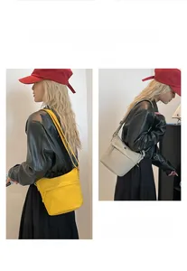 Minimalist nylon crossbody bucket bag in yellow and beige with adjustable shoulder straps