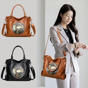 Retro ethnic tote bag with elephant embossment and wide strap in black and brown