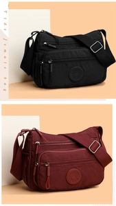 Close-up of waterproof nylon crossbody bags in black and wine red with adjustable straps