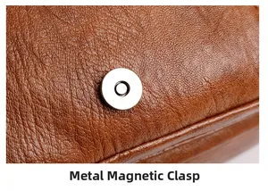 Detail of premium silver magnetic hardware closure on a brown lychee textured leather bag