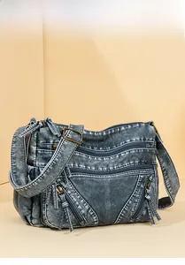 Detail of vintage blue crossbody bag with multiple zip pockets and adjustable strap