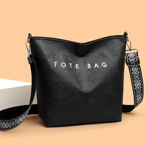 Sac fourre-tout noir minimaliste avec texte et bandoulière tissée à motifs géométriques