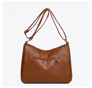 Rear view of brown PU leather crossbody bag showing back zipper pocket and stitching