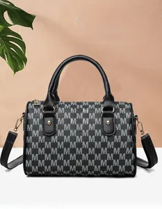 Detailed view of the black and gray monogram M print on a chic Boston shoulder bag