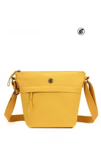 Detailed front view of a yellow nylon crossbody bucket bag with wide fabric strap